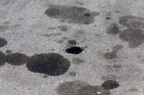 Oil and fuel stains on asphalt surface