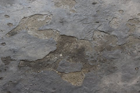 Concrete surface showing spalling and worn deterioration
